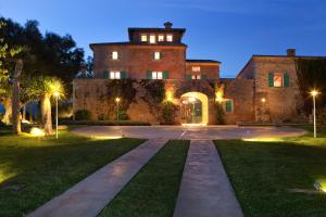 a large brick building with a tower on top at Sa Cabana Hotel & Spa - Adults Only in Consell
