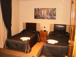En eller flere senge i et værelse på Hotel Restaurante El Colono
