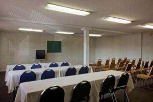 a conference room with a long table and chairs at Days Inn by Wyndham Hemet in Hemet +6 photos
