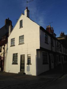 a white building sitting on the side of a street at The Corner House in Whitby