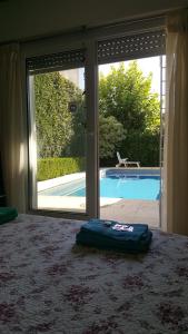 a room with an open door to a swimming pool at Lo de Lala B&B con Energía Solar in Acassuso