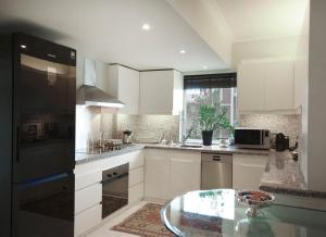 A kitchen or kitchenette at Athens Lycabettus Hill Penthouse, Private Roof Garden & Pool
