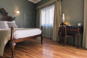 a bedroom with a wooden floor and wooden furniture at Hotel Sao Jose in Porto