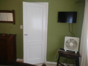 a room with a white door and a fan at Departamento Legarra Mar in Miramar