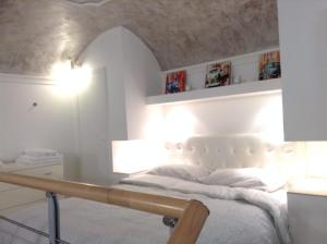 a bedroom with a white bed and a table at Glamour Suite Duomo in Florence
