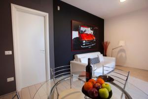 a room with a glass table with a bowl of fruit at Villino Erminia - Seaside Art b&b in Pizzo