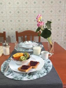 a table with a plate of bread and fruit on it at B&B LA DOLCE VITA in Gragnano