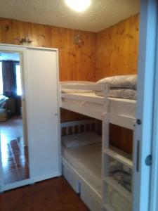 a room with two bunk beds in a room at margue residence meledrio in Folgarida