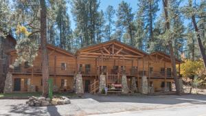 a large log home with a large deck at Upper Canyon Inn & Cabins in Ruidoso