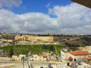 a view of the old city of jerusalem with the dome of the rock at Jerusalem Panorama Hotel in Jerusalem