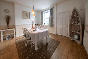 a dining room with a white table and chairs at Harrogate 100 in Harrogate