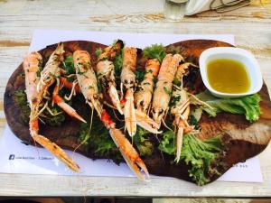 a plate of food with carrots on a cutting board at Cactus Beach Paros in Logaras