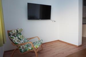 a living room with a chair and a flat screen tv at Landhaus Schaidreith in Ferschnitz