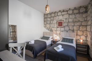 オラサックにあるHoliday Home Fridaの石壁のドミトリールーム ベッド2台