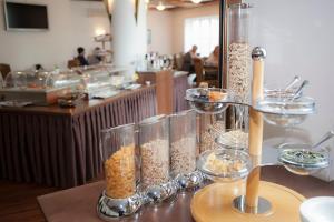 a table with a bunch of containers of food at Hotel Theresientor in Straubing