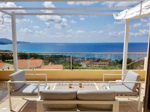 a balcony with a view of the ocean at Zambrone village in Zambrone