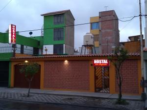 a building with a sign on the side of it at Hostal Las Begonias in Arequipa