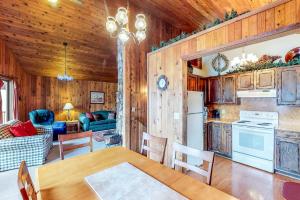 a kitchen and living room with a table and a dining room at Ponderosa Cabin in Cascade