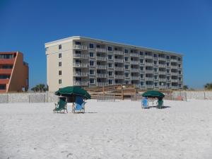 due sedie e ombrelloni sulla spiaggia di fronte a un hotel di Best Gulf-Front Beach View in Destin! a Destin