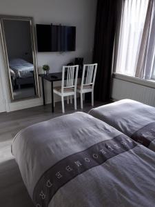 
Een bed of bedden in een kamer bij B&B de Noorman
