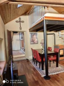 a dining room with a loft bed and a table and chairs at Il Castello delle Fiabe in Scandeluzza +60 photos
