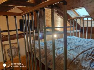 a bed in a room with a wooden ceiling at Il Castello delle Fiabe in Scandeluzza