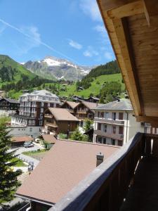 a view from a balcony of a town with mountains at Sportchalet Mürren in Mürren