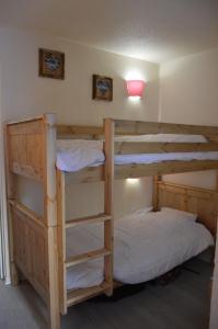 two bunk beds in a room with a lamp at Résidence Andromède in Belle Plagne