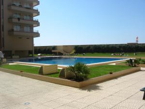 a swimming pool with two lounge chairs next to a building at BARRAMARES 2 in Ovar