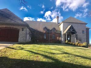 a large brick house with a garage at Affordable Luxury Mansion in Quincy