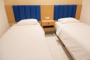 Postel nebo postele na pokoji v ubytování Kokonut Guesthouse