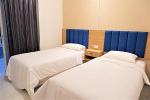 Postel nebo postele na pokoji v ubytování Kokonut Guesthouse