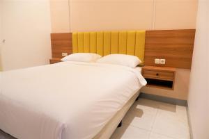 Postel nebo postele na pokoji v ubytování Kokonut Guesthouse