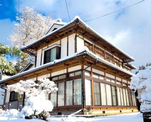 uma casa coberta de neve na frente em Matakitai em Ichinoseki