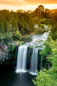 a waterfall in the middle of a river at Lookout Mountain Retreat in Dorrigo