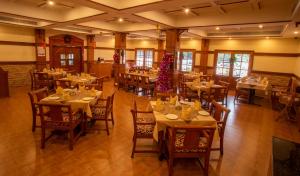 a dining room with tables and chairs with christmas decorations at Quality Airport Hotels in Nedumbassery