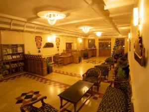 a large room with chairs and tables in a building at Quality Airport Hotels in Nedumbassery +25 photos