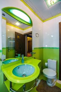 a green bathroom with a toilet and a sink at BAKU CITY CENTER 4. Bedrooms 4. in Baku