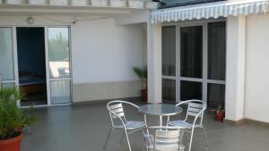 a patio with a table and chairs on a balcony at Villa Climate Guest House in Varna City