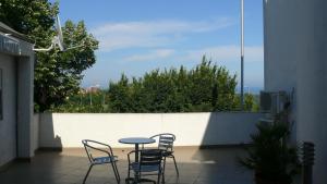 a patio with chairs and a table on a balcony at Villa Climate Guest House in Varna City