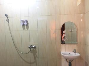 a bathroom with a shower and a sink at Bamboo Bungalow Jungle View in Nusa Penida