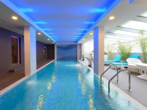a swimming pool in a hotel with a blue ceiling at Agusta Spa Hotel in Veliko Tŭrnovo
