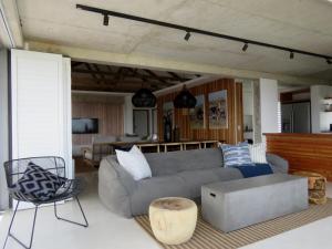 a living room with a couch and a table at Troon Beach Cottage Hermanus in Hermanus