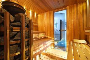 a sauna with wooden walls and a glass door at Vila Moldavia Class in Slănic-Moldova