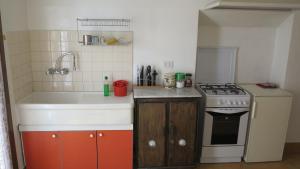 a small kitchen with a sink and a stove at B&B Del Teatro in Sulmona