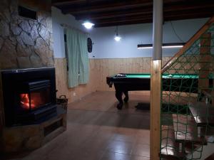 a room with a pool table and a fireplace at Chata Daniela in Liptovská Osada