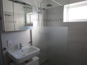 a white bathroom with a sink and a shower at Historisches Fachwerkhaus in Reifferscheid +18 photos