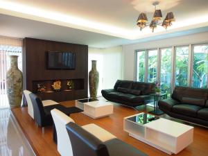 a living room with a couch and a table at The Porch ABAC Bangna in Samutprakarn
