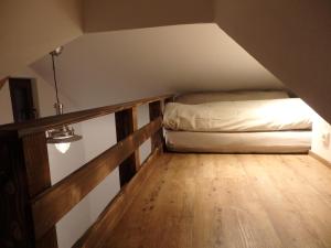 a small bedroom with a bed in a attic at Amsel Haus in Bayrischzell