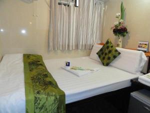 Postelja oz. postelje v sobi nastanitve First Inn Hotel & Guest House Reception at 10TH F, Block E
